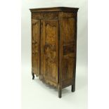 An 18th Century French walnut and burr panelled armoire in the Louis XV Provincial taste,