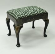 A 19th Century black lacquered and chinoiserie decorated dressing stool on cabriole legs to pad