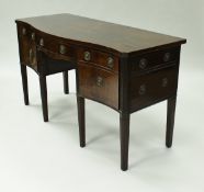 A late George III mahogany serpentine fronted sideboard,