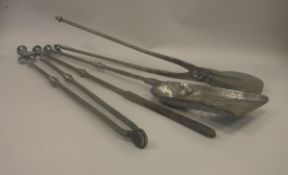 A set of three early 19th Century steel fire irons together with a scissor action biscuit press