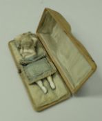 A cased set of three Meerschaum cheroot holders, coming together to depict a sleeping woman,