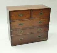 A Victorian teak and brass bound military chest in two sections with two short drawers,
