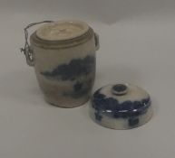 A Chinese blue and white pot and cover with inner cover decorated with a coastal landscape and