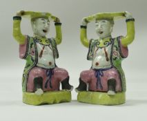 A pair of 19th Century Chinese polychrome decorated figures as stands in the Ming style each as a