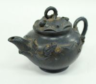 A Chinese blue Yixing teapot decorated in relief with frogs, snails and lilies,