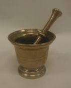 An 18th Century bronze mortar of inverted bell form together with pestle 11.