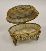 A 19th Century gilt brass and enamelled casket of oval form depicting flowers and raised on ram's