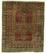 A Hatchill Bokhara rug, the central panel set with four tile panels, within a stepped geometric red,