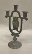A Coberg German Arts & Crafts candelabra decorated with a perching owl raised on a circular