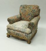 A pair of circa 1900 armchairs, the plain backs above scroll arms to carved base rail,