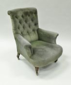 A Victorian button back upholstered scroll armchair on turned front legs to brass caps and casters