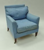 A near matching pair of circa 1900 upholstered armchairs by Howard of London raised on square