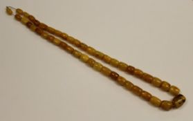 A single strand graduated Baltic amber bead necklace, approx 74.5 cm long, 85.