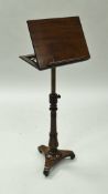 A Victorian mahogany adjustable reading table, the plain top with book holder on a ratchet,