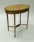 An Edwardian mahogany and inlaid occasional table, the oval top with inlaid decoration,