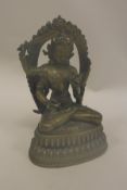 A Tibetan bronze figure of manjushri with four arms a sword in her right hand and various other