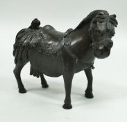 A Chinese bronze figure of a ceremonial horse with elaborate saddle and other embellishments