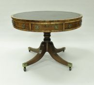 A 19th Century rosewood drum table, the tooled and gilded leather insert top over frieze drawers,