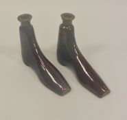 A pair of circa 1820 treacle glazed pottery "boot" flasks, 13.5 cm long x 10.