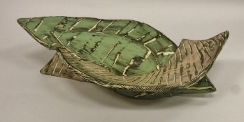 CAROL MCNICHOLL (b. 1943) - a footed bowl of scrolling form, signed to base, approx 45.