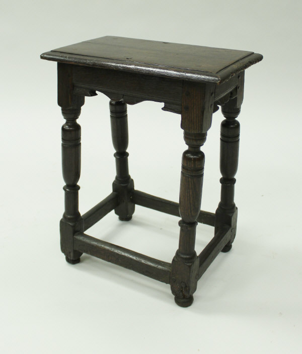 A 17th Century and later joined oak stool,