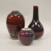 Three sang-de-beouf vases of various shapes and sizes, one with an impressed potter's mark "CL",