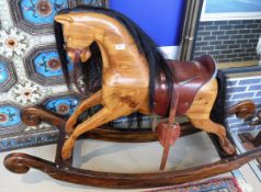 A modern pitch pine rocking horse pokerwork inscribed to base "handmade bare-back rocker No.