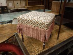 A Victorian upholstered foot stool on slender turned and ringed mahogany supports