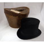 A 1910 Christie silk top hat in original leather case together with a vintage leather suitcase
