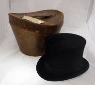 A 1910 Christie silk top hat in original leather case together with a vintage leather suitcase