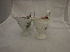 Two 18th Century Newhall porcelain cream jugs of helmet form,