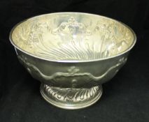 A Victorian silver punchbowl with embossed decoration raised on a circular foot (by James Deakin &