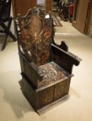 A 19th Century child's chair with hand painted decoration and crest to the back panel