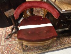 A Victorian yoke back oak framed and upholstered office chair with cushion seat on turned and