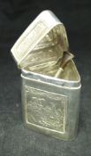 A circa 1900 Continental silver lidded box of triangular form decorated with panels of agricultural
