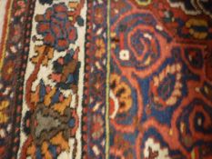 A Persian style rug,