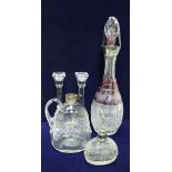 An amethyst overlaid cut glass decanter with silver rim, a cut glass jug with silver rim,