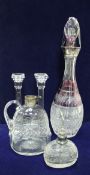 An amethyst overlaid cut glass decanter with silver rim, a cut glass jug with silver rim,