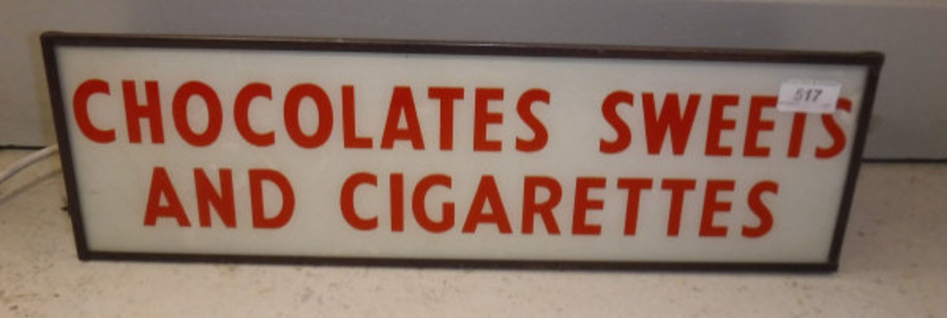 A mid 20th Century lightbox sign inscribed "Chocolates,