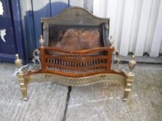 A modern cast iron and brass fire basket in the Regency taste