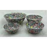A set of four graduated Republic era Chinese millefleurs bowls with wooden stands