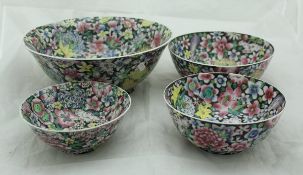 A set of four graduated Republic era Chinese millefleurs bowls with wooden stands