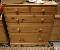 A modern pine chest of two short over three long drawers to bracket feet