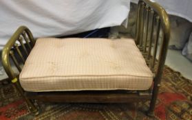 An early 20th Century brass doll's bedstead with sprung base and mattress together with a Davos