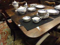 An early Victorian mahogany drop leaf dining table on turned and faceted legs to brass caps and