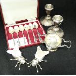 A pair of Godinger plated and glass salt/peppers of insect form, a silver tea strainer and stand,