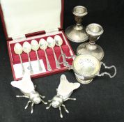A pair of Godinger plated and glass salt/peppers of insect form, a silver tea strainer and stand,