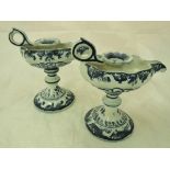 A pair of Continental tin glazed pottery blue and white chamber sticks,