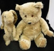 A gold plush bear with jointed arms and legs,