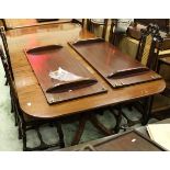 A reproduction mahogany rounded rectangular extending dining table with top with reeded edge and